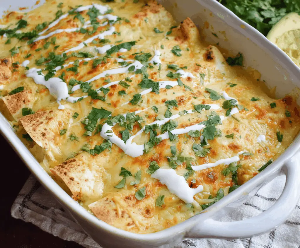 Delicious low carb white chicken enchiladas topped with melted cheese and fresh cilantro on a plate