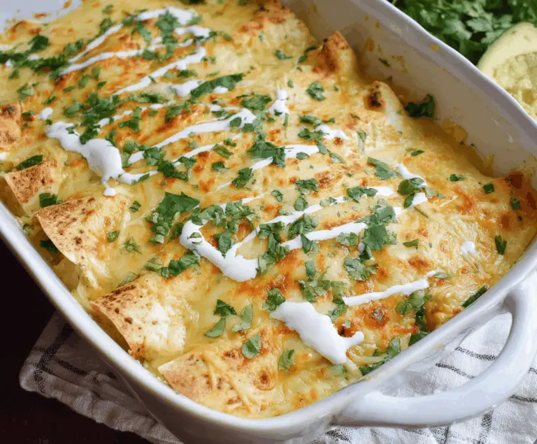 Delicious low carb white chicken enchiladas topped with melted cheese and fresh cilantro on a plate