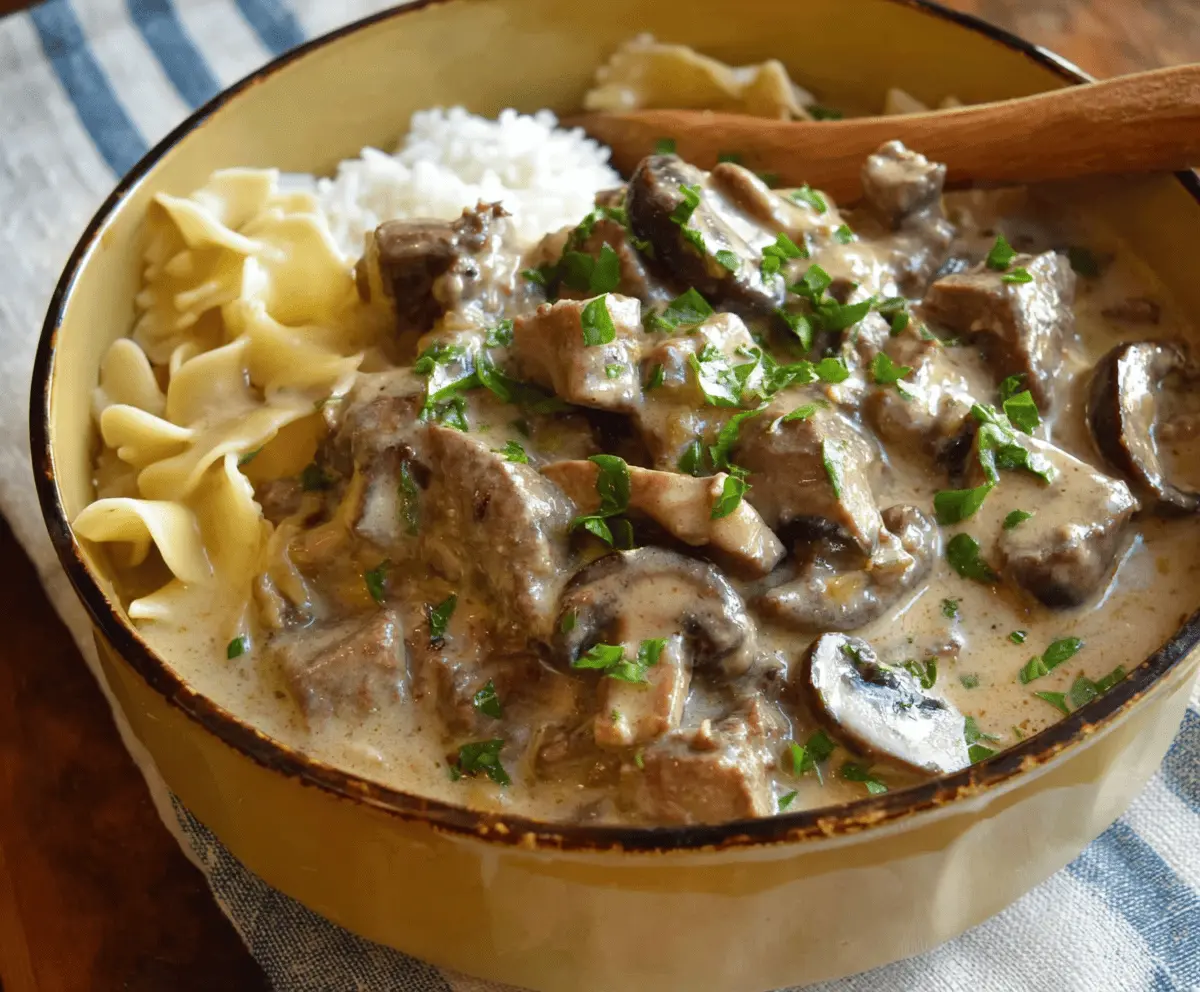 Creamy Slow Cooker Beef Stroganoff Stew with tender beef, mushrooms, and savory sauce served in a bowl