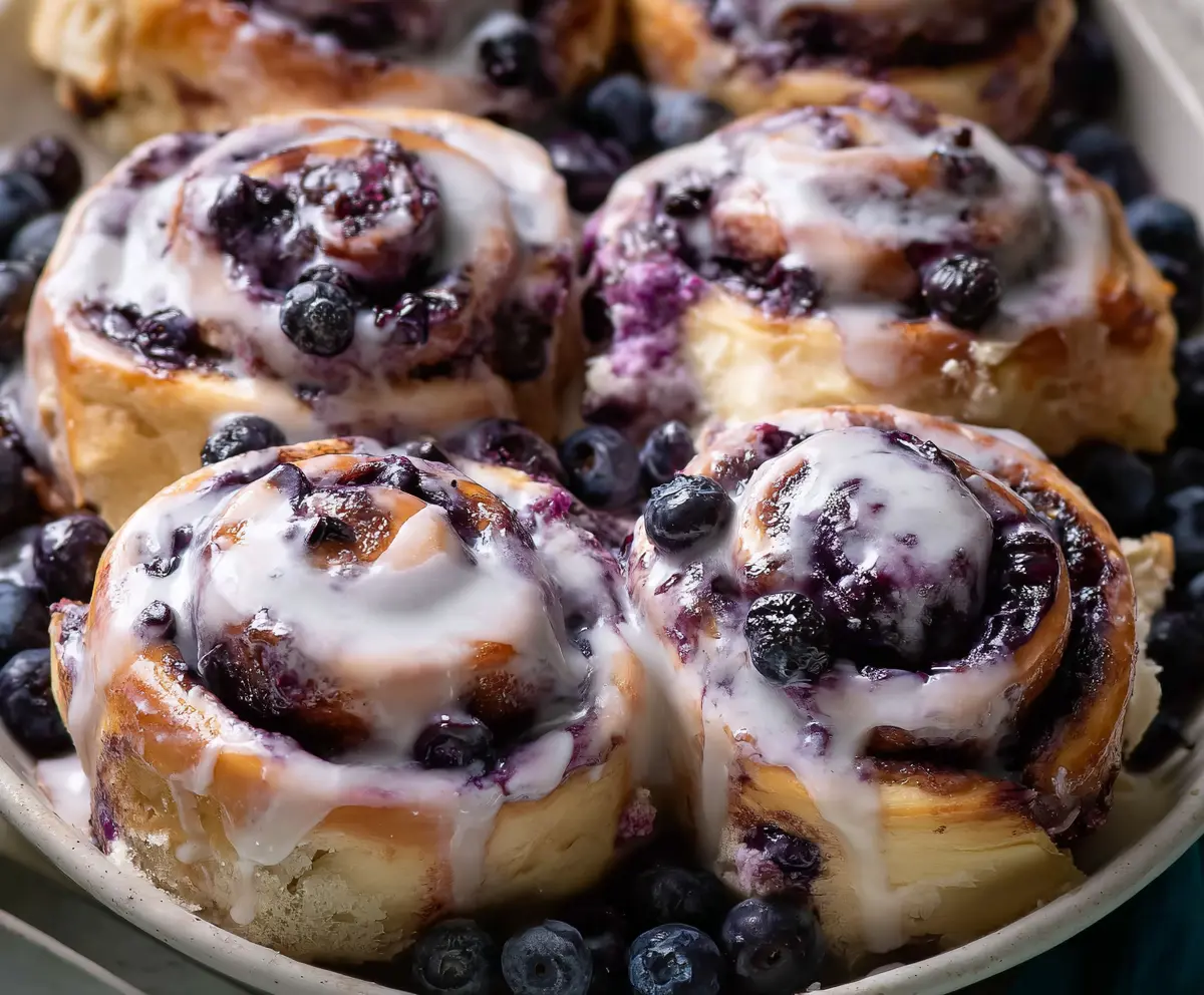 Delicious blueberry cinnamon rolls topped with icing, perfect for breakfast or brunch.