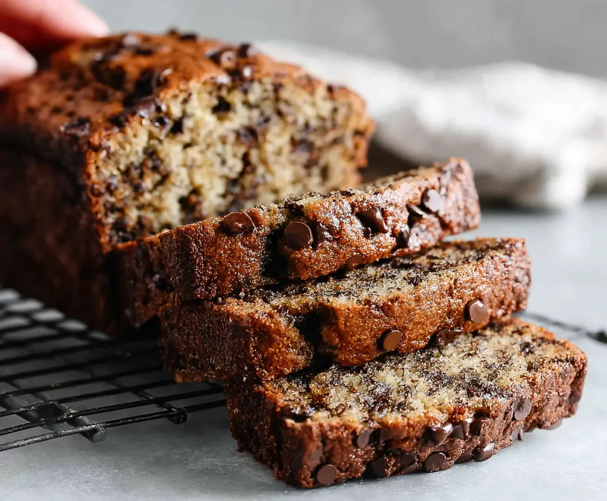 Delicious homemade chocolate chip banana bread fresh out of the oven with melted chocolate chips and ripe bananas.