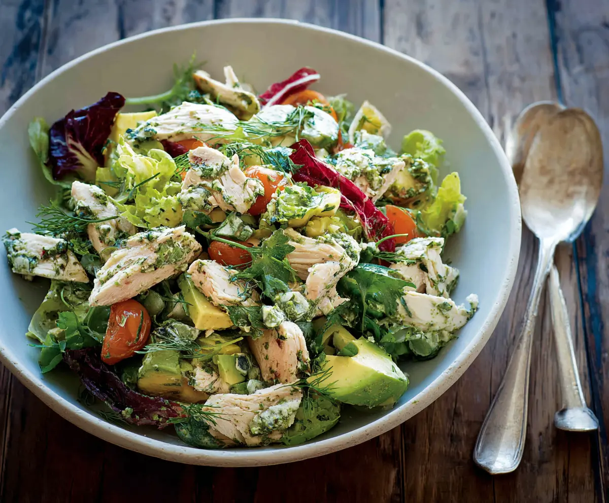 Fresh Green Goddess Chicken Salad with leafy greens, herbs, and grilled chicken in a vibrant dish.