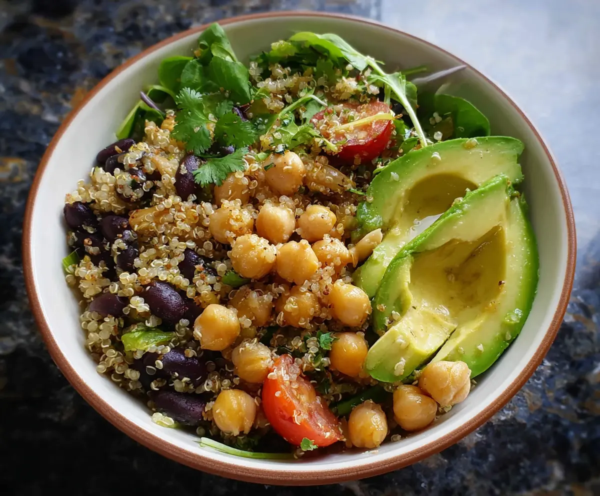 Healthy quinoa bowl with fresh avocado slices and chickpeas, perfect for a nutritious meal.
