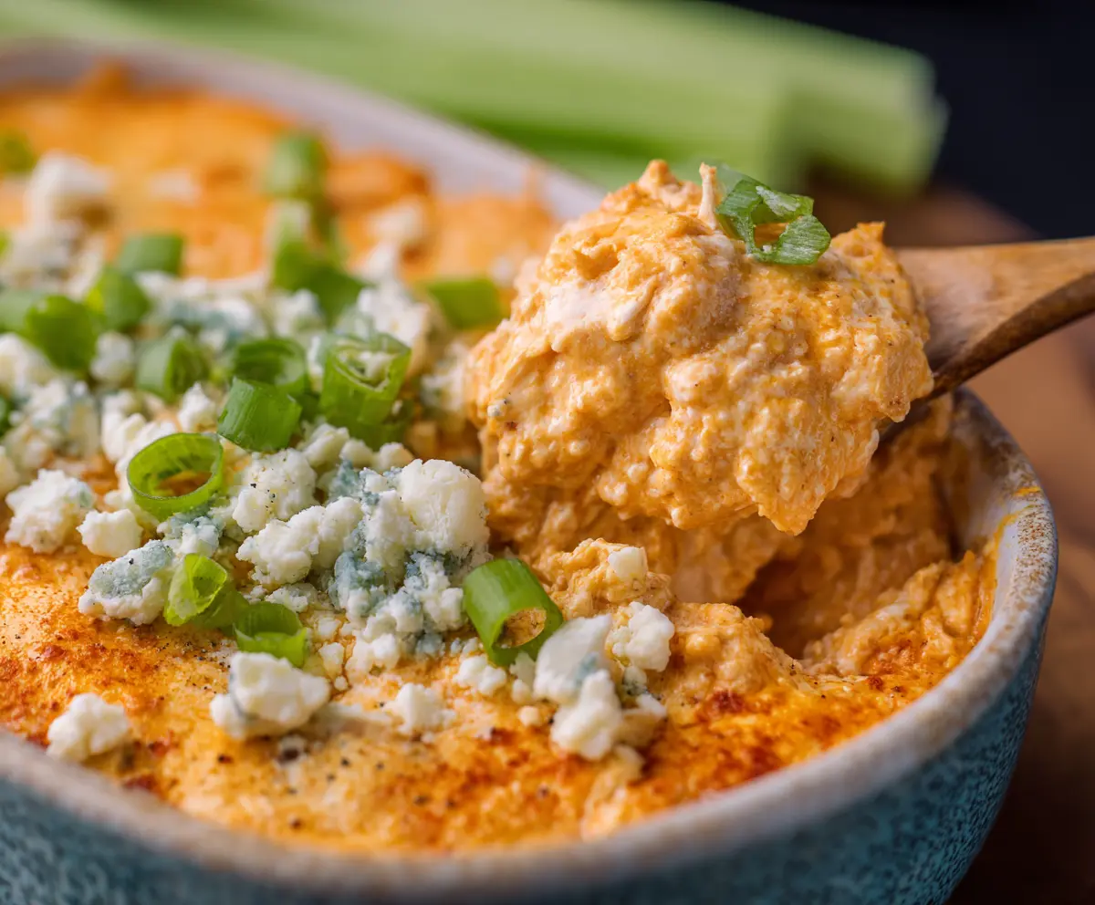 Spicy Buffalo Chicken Dip with Frank’s RedHot sauce served in a bowl with celery sticks for a hot appetizer.