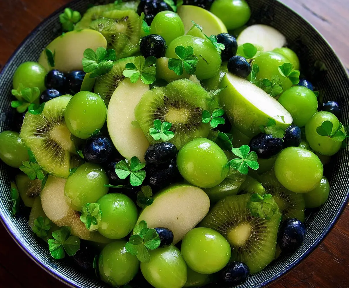 Colorful green fruit salad for St. Patrick’s Day celebration, featuring fresh kiwi, grapes, and lime.