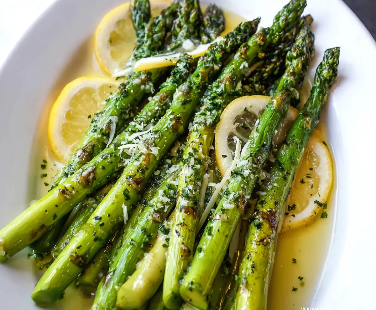 Fresh lemon butter glazed asparagus spears garnished with lemon zest