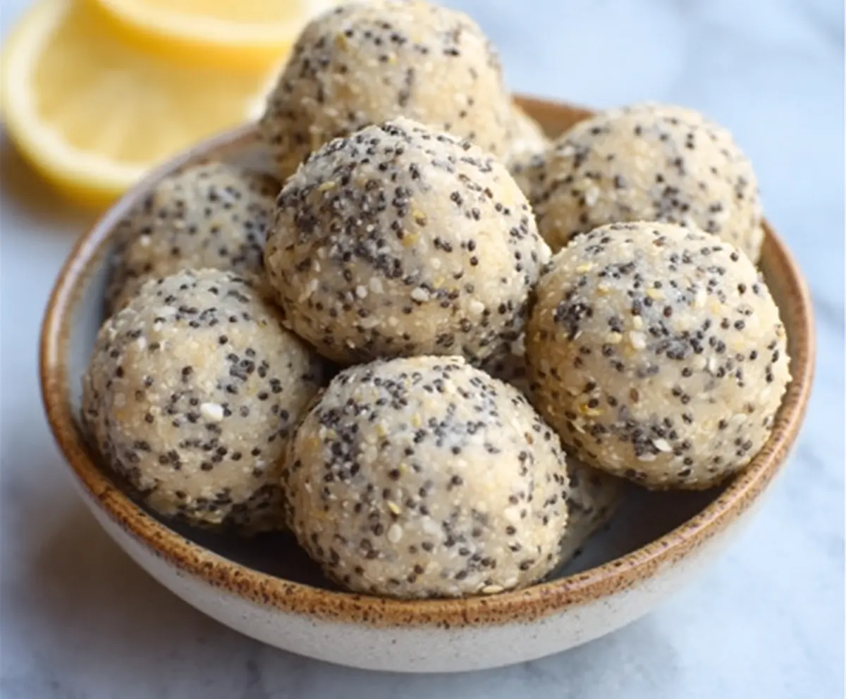 Delicious Lemon Poppy Seed Energy Bites on a white plate, showcasing a bright and fresh snack with lemon zest and poppy seeds.